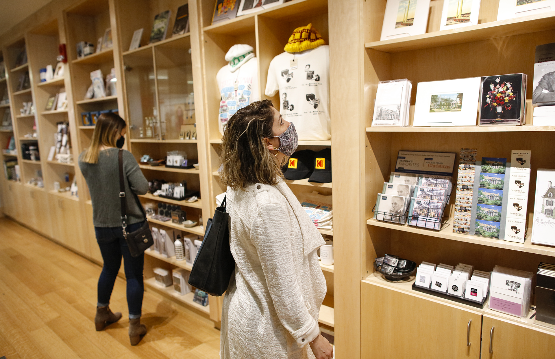 Person looking at shelves of merchandise in museum shop