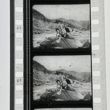 35mm film fragment depicting Rangeela on a rock.