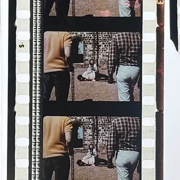 35 mm film fragment depicting a man on the ground with a woman.