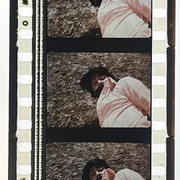35mm film fragment depicting a man on the ground.