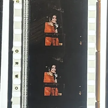 35mm film fragment depicting a woman in red.