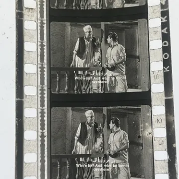 35mm film frames depicting two men talking.