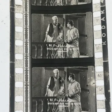 35mm film frames depicting two men talking.