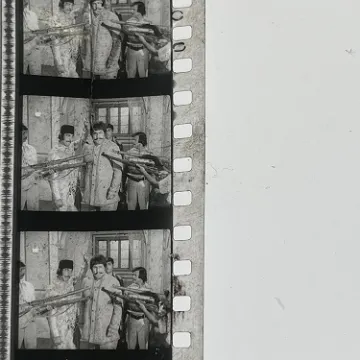 35mm film frames depicting group of men.