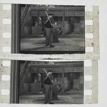 35mm film fragment depicting a man cleaning.