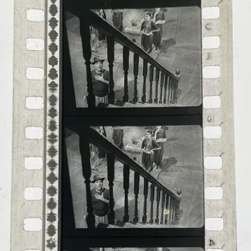 35mm film fragment depicting a man cleaning.