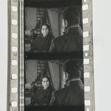 35mm film frames depicting woman talking with man.