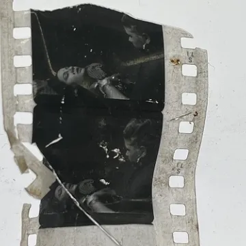 35mm film frames depicting woman talking with man.