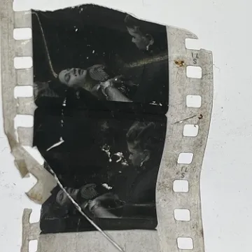 35mm film frames depicting woman talking with man.