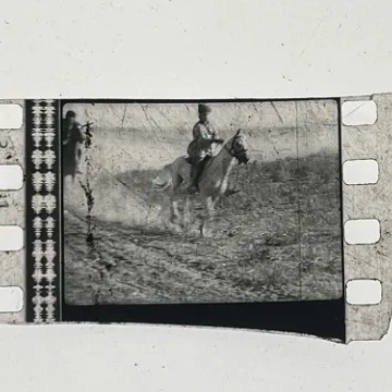 35mm film fragment depicting a man on a horse.