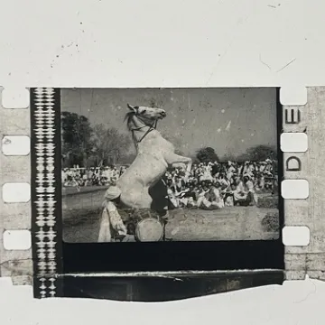 35mm film fragment depicting a man on a horse.