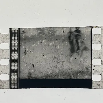35mm film fragment depicting a man on a horse.