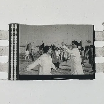 35mm film frames depicting men in white fighting.