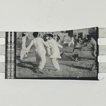 35mm film frames depicting men in white fighting.