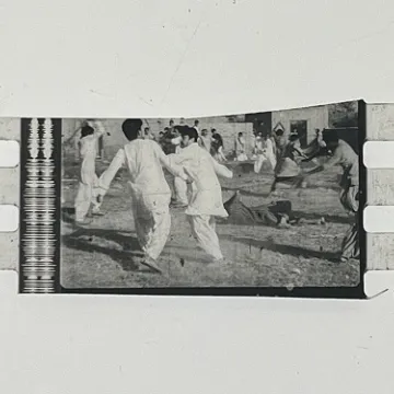 35mm film frames depicting men in white fighting.