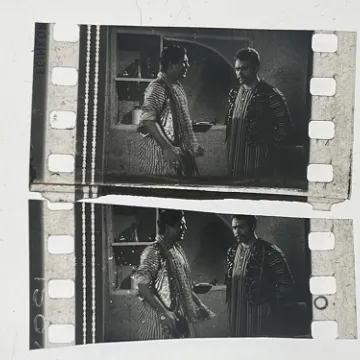 35mm film fragment depicting Sultan Rahi with a man.