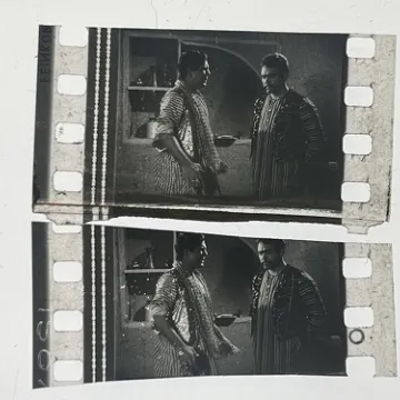 35mm film fragment depicting Sultan Rahi with a man.