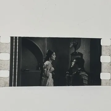 35mm film fragment depicting Sultan Rahi with a woman.