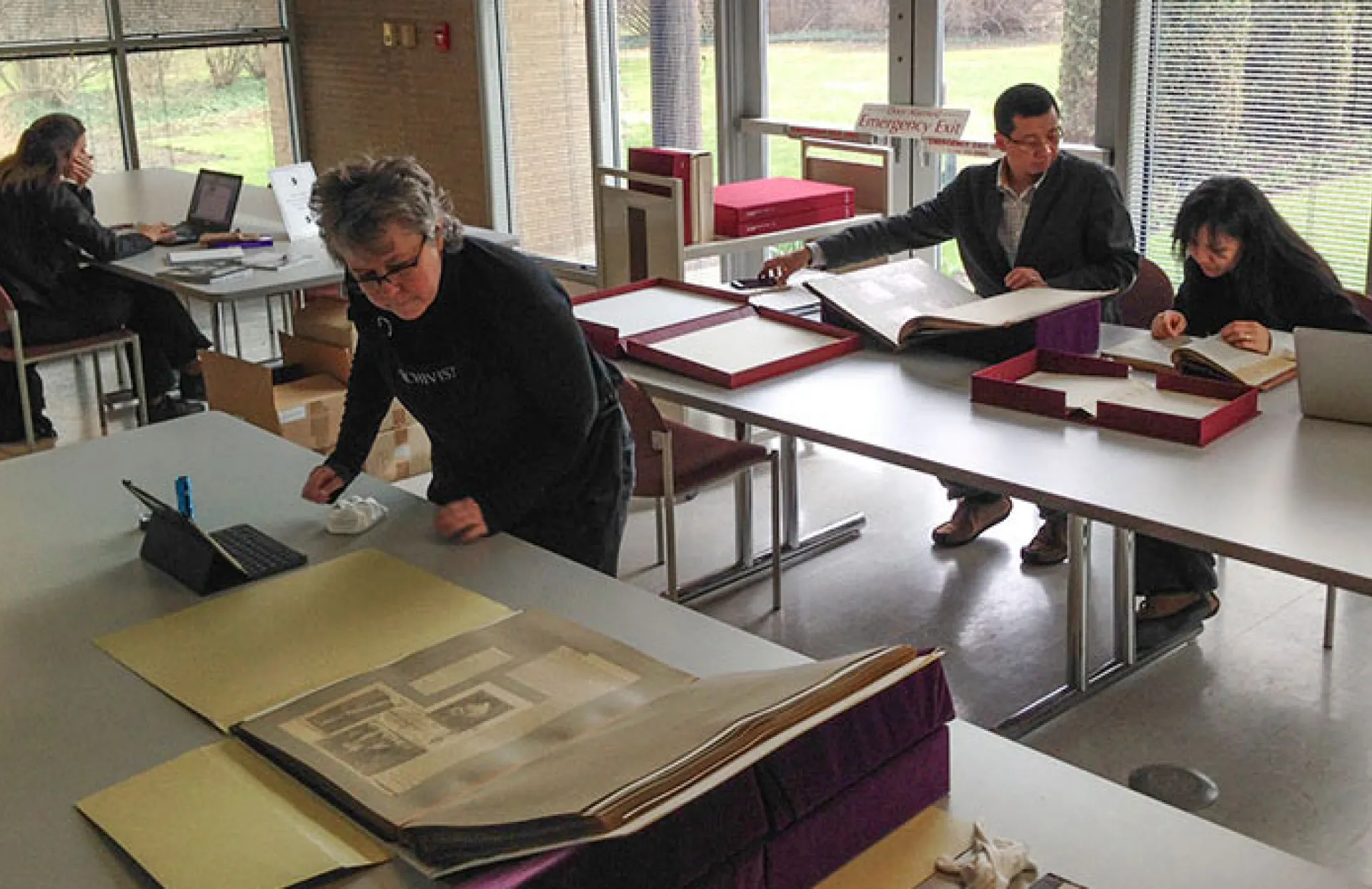 Researchers in the library looking at historic books