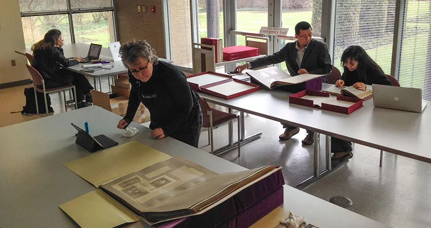 Researchers in the library looking at historic books