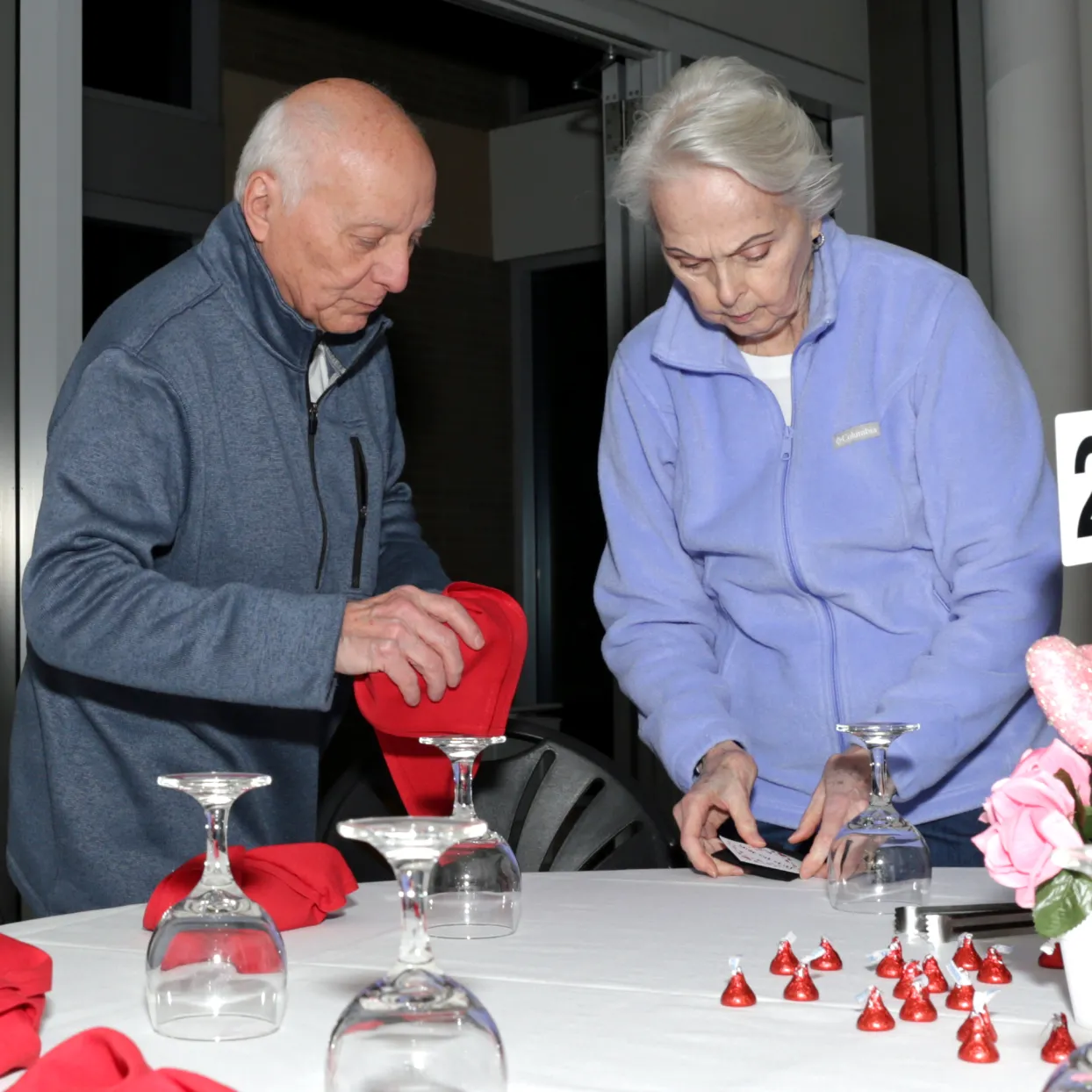 Council members setting tables for the 2025 Valentine's Day Brunch & Film