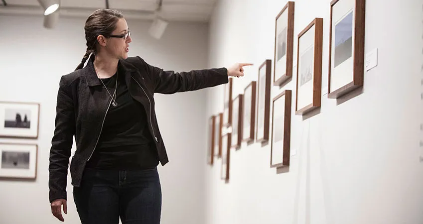 Curator discussing a photograph on view
