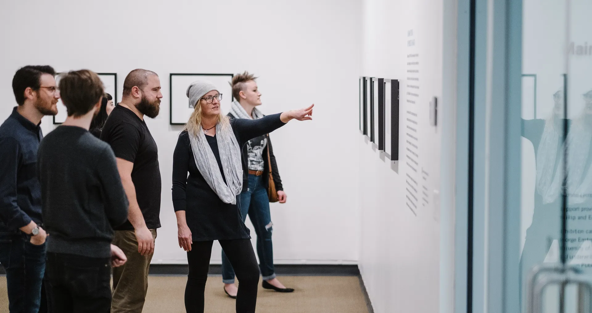 Guests in gallery looking at photographs