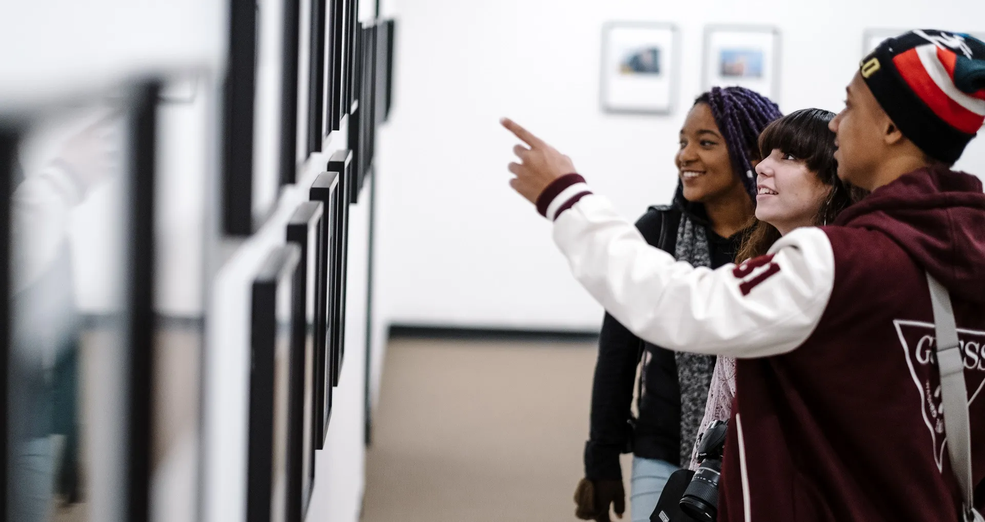Guests in gallery looking at photographs