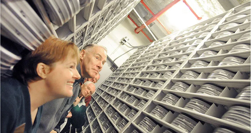 Guests look at film reels from the collection