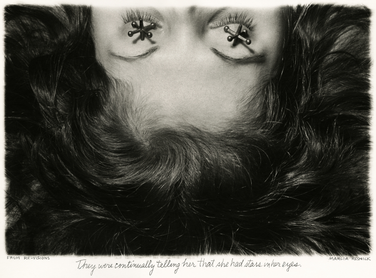 Shot of half a woman's face seemingly laying down with jacks (the kids toy) over her eyes