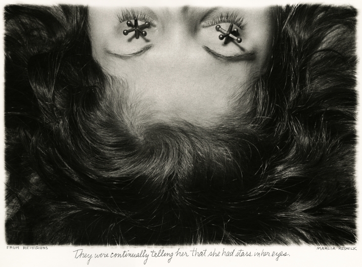Shot of half a woman's face seemingly laying down with jacks (the kids toy) over her eyes