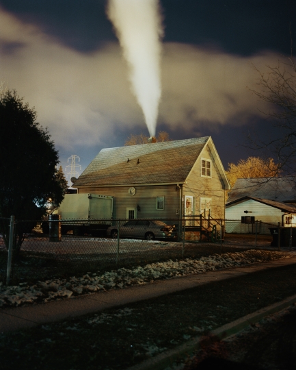 A house with steam coming out of the chimney 