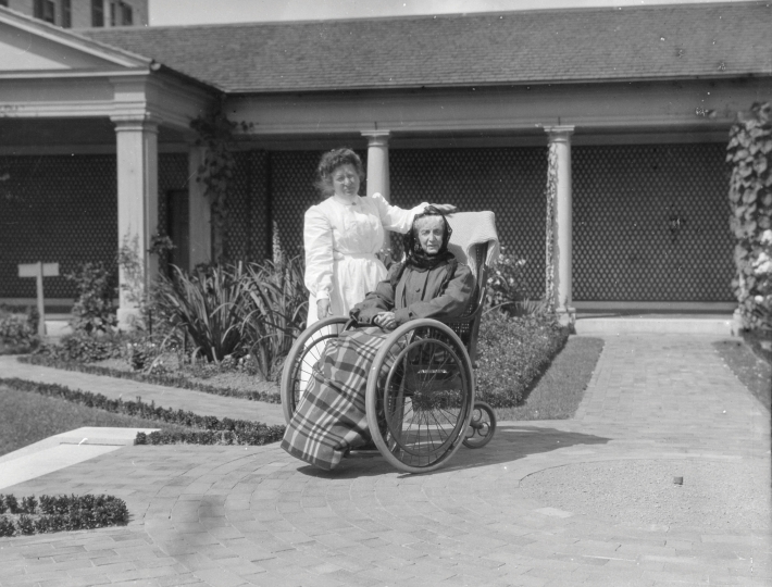 Maria Eastman in garden, 1905‐1907.