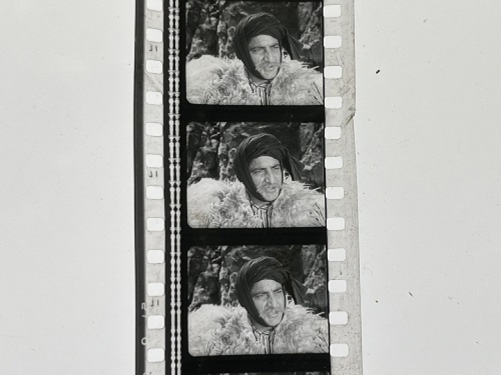35mm film fragment depicting a man in fur.