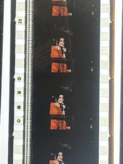 35mm film fragment depicting a woman in red.