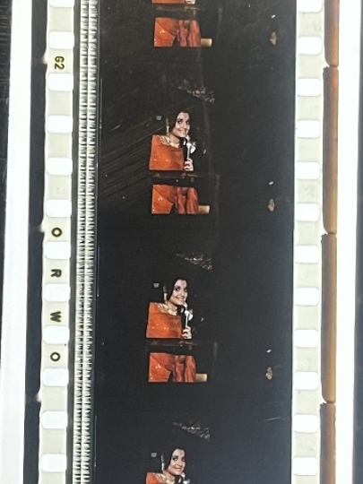 35mm film fragment depicting a woman in red.