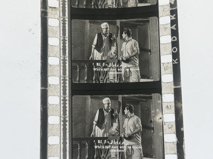 35mm film frames depicting two men talking.