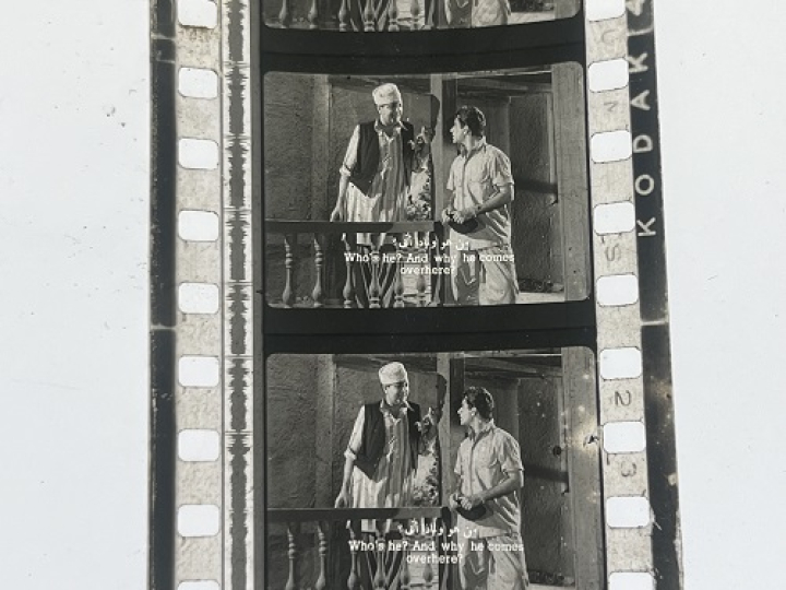 35mm film frames depicting two men talking.