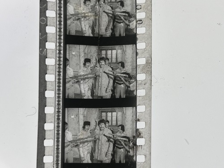 35mm film frames depicting group of men.