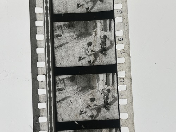 35mm film frames depicting two men fighting.