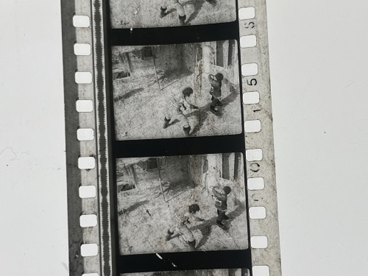 35mm film frames depicting two men fighting.