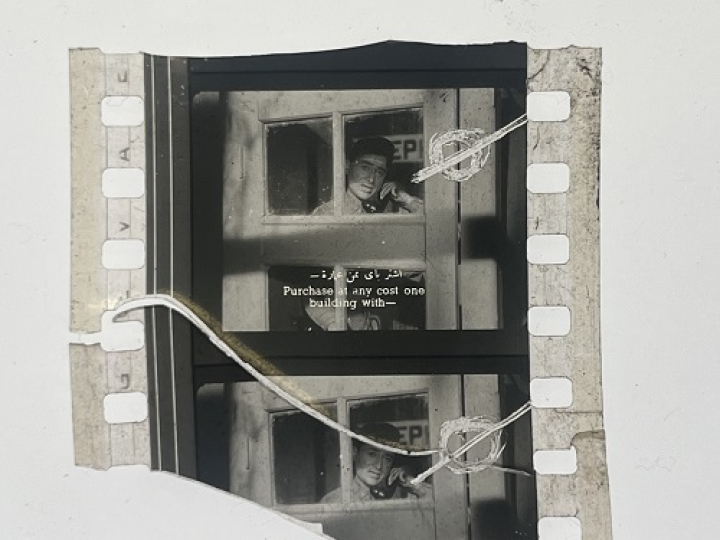 35mm film fragment depicting a man talking on the phone.