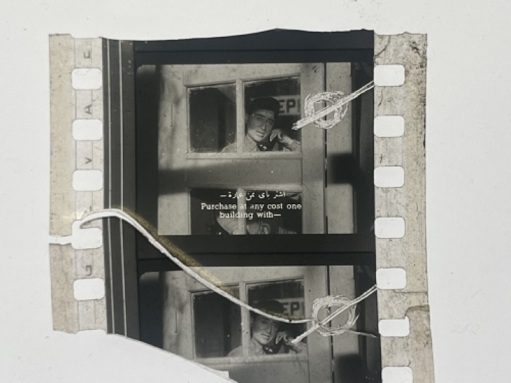 35mm film fragment depicting a man talking on the phone.