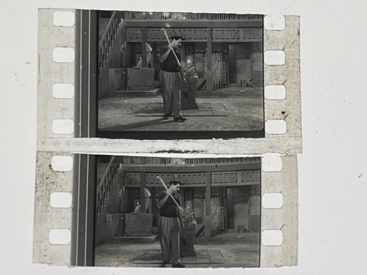 35mm film fragment depicting a man cleaning.