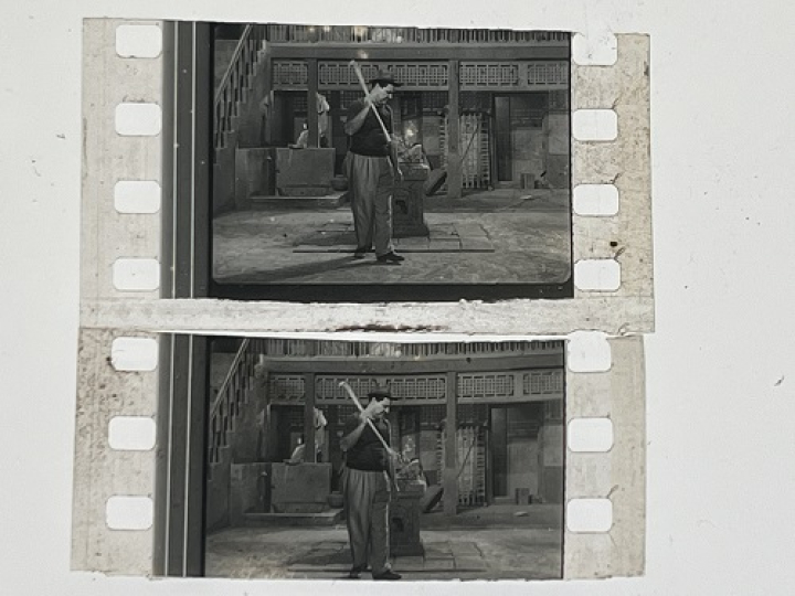 35mm film fragment depicting a man cleaning.