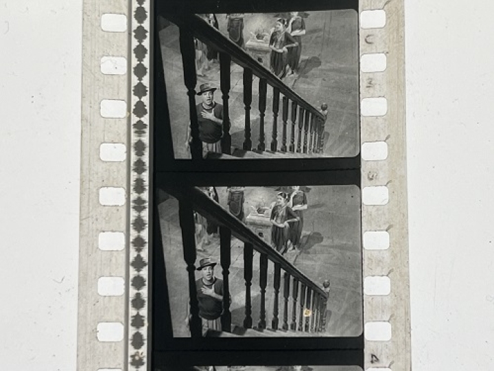 35mm film fragment depicting a man cleaning.