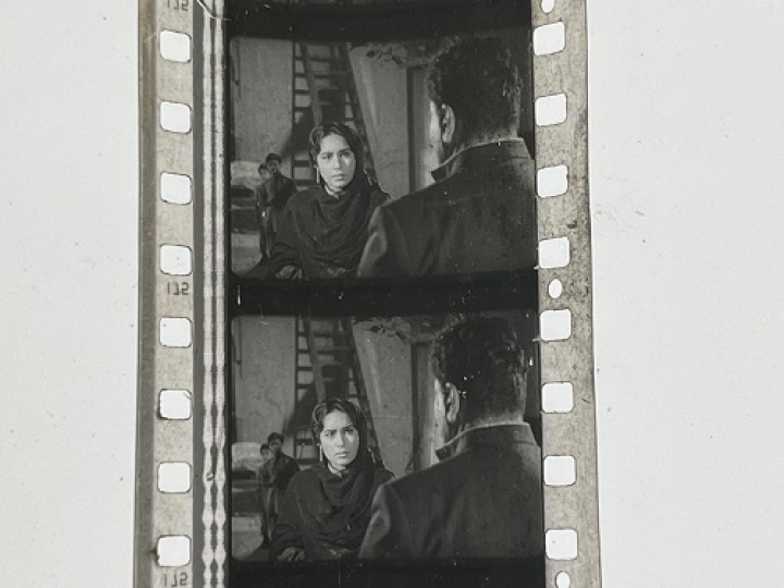 35mm film frames depicting woman talking with man.