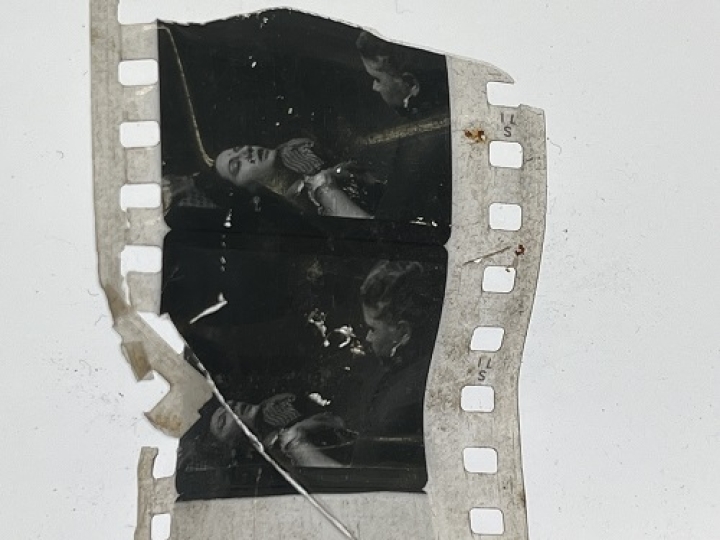 35mm film frames depicting woman talking with man.