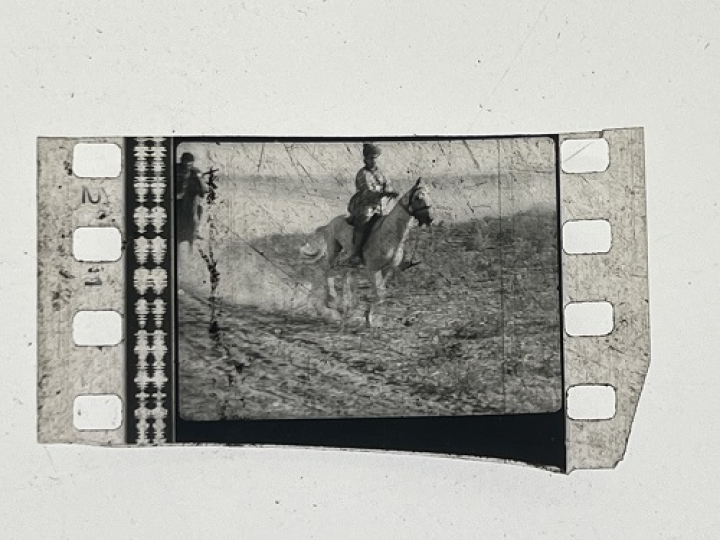 35mm film fragment depicting a man on a horse.