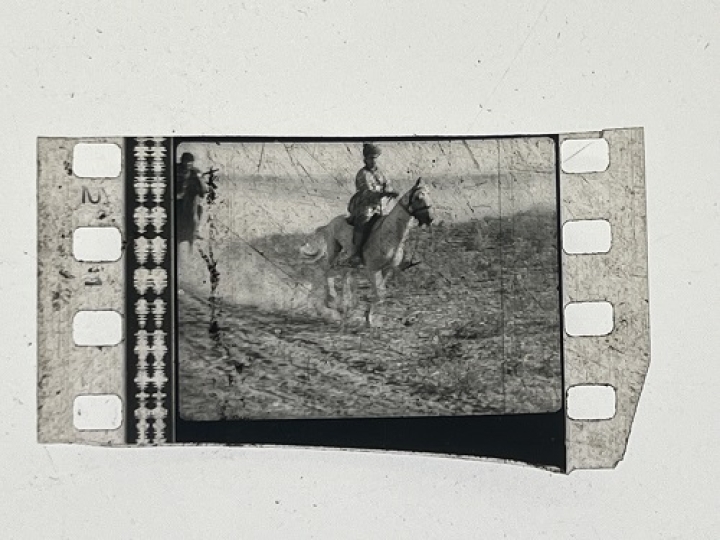 35mm film fragment depicting a man on a horse.